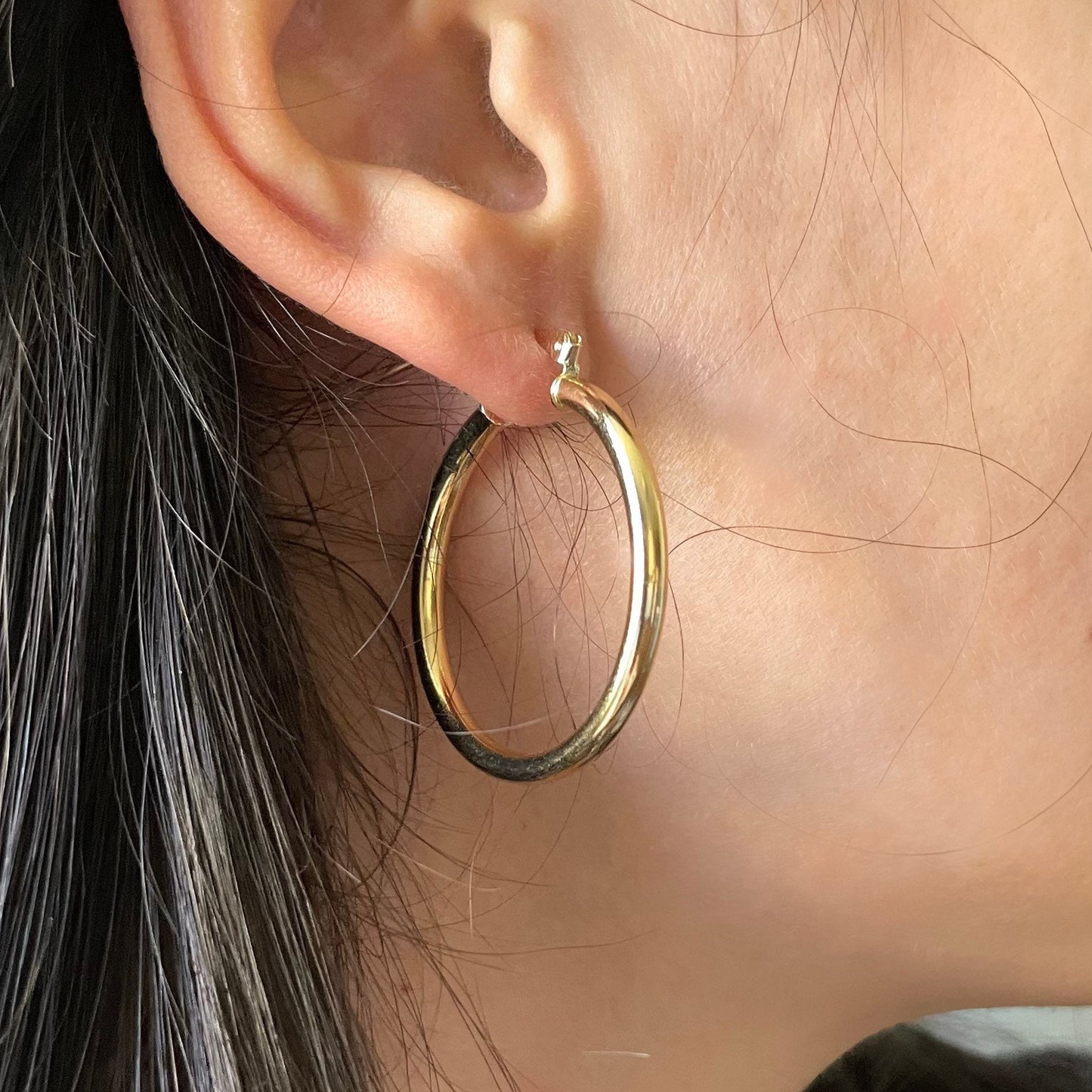 18k gold filled timeless hoop earrings wore by a woman