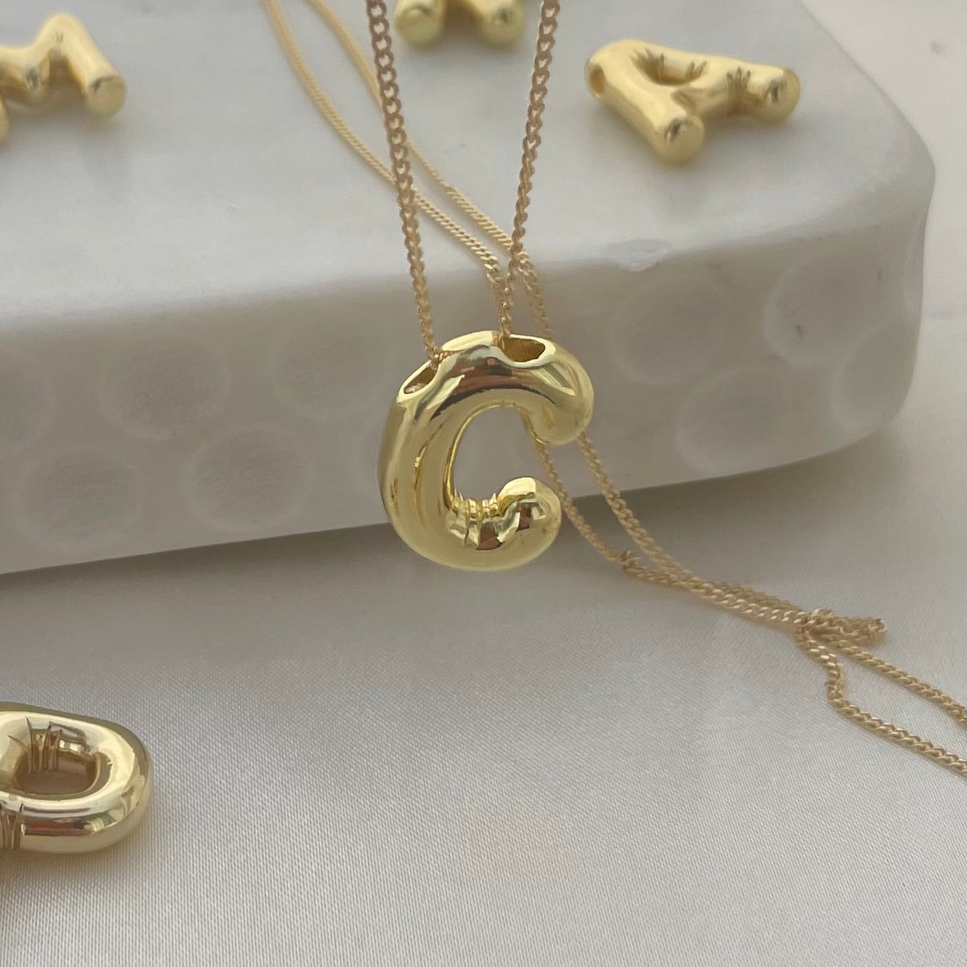 hanging C Initial Pendant Necklace, white background 