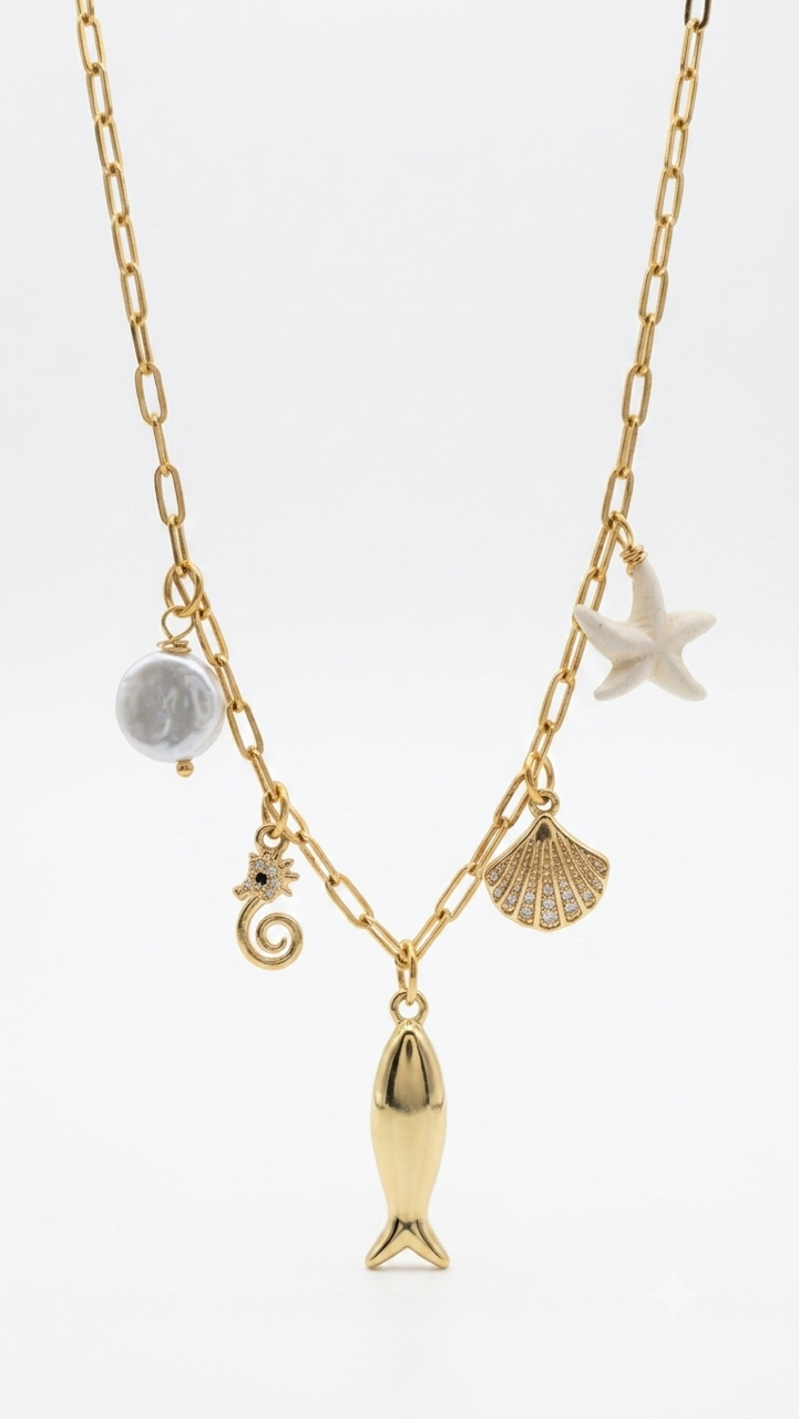 Gold filled paperclip chain with multi charms as fish, seahorse, shell, starfish, flat pearl over white background