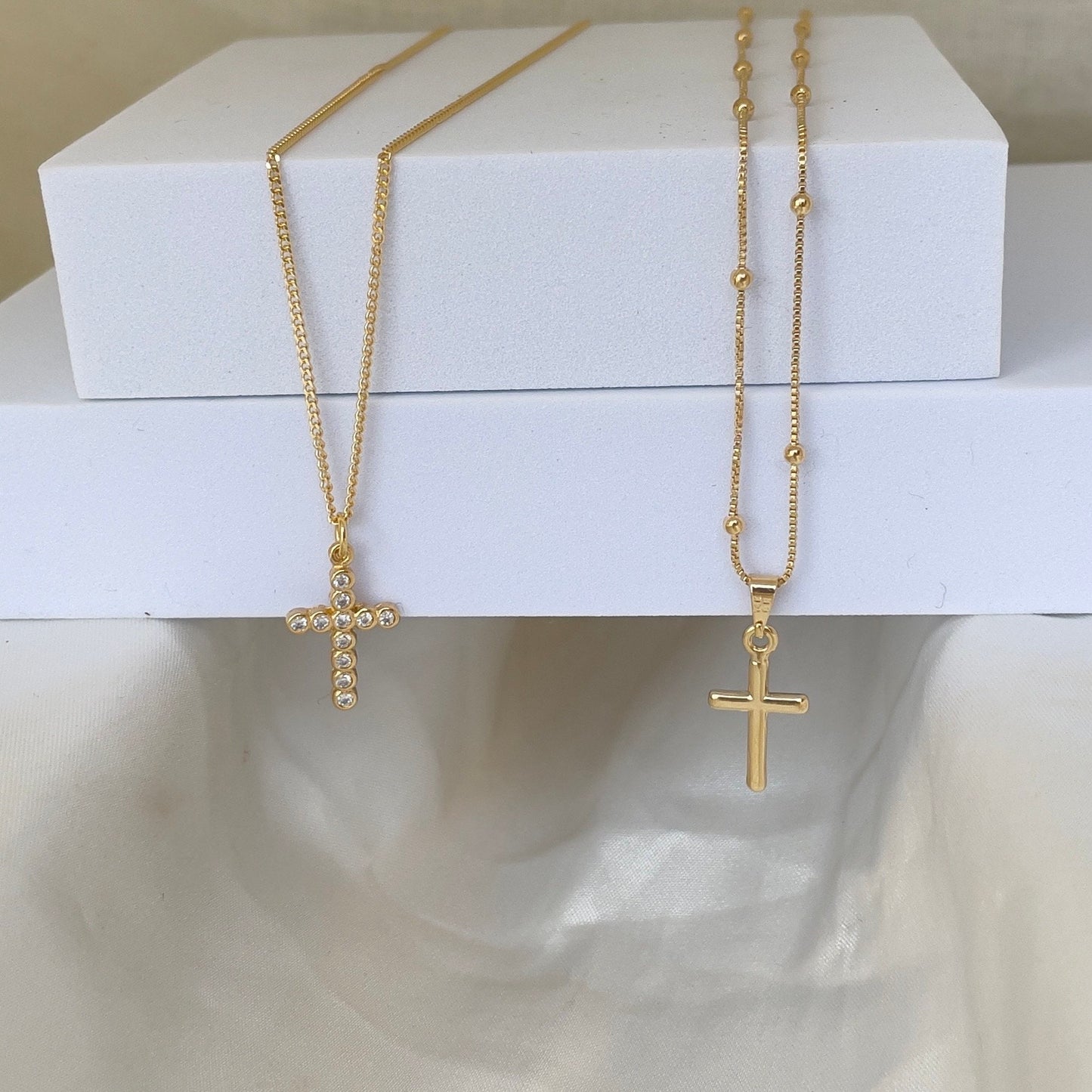 Cross Necklace, plain gold cross pendant and cz cross pendant. Materials: 18k gold filled and cz, white background