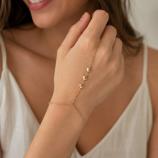 Woman wearing a gold filled hear hand chain 