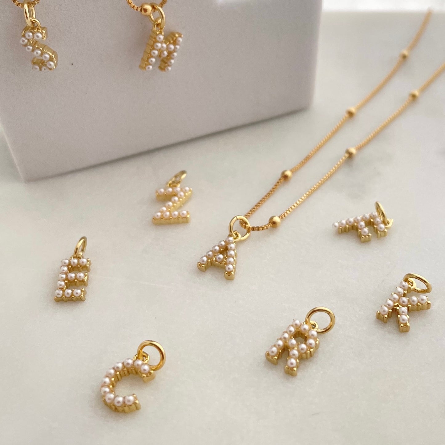 Close up to Gold initial necklace on display 