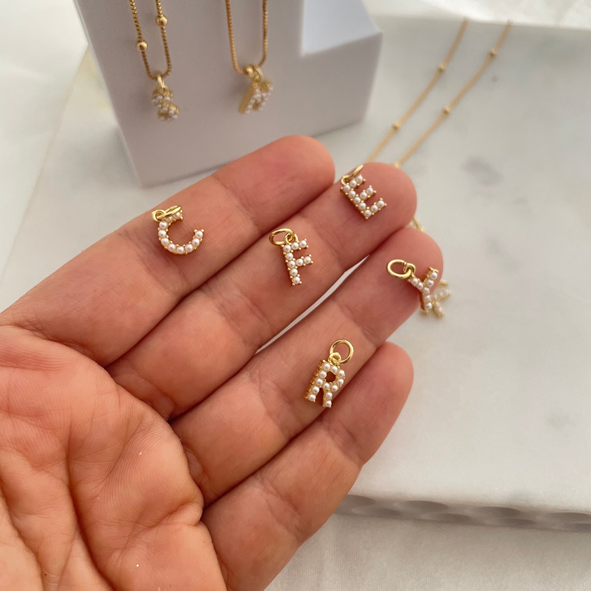 Detail of pearl letter necklace gold filled 