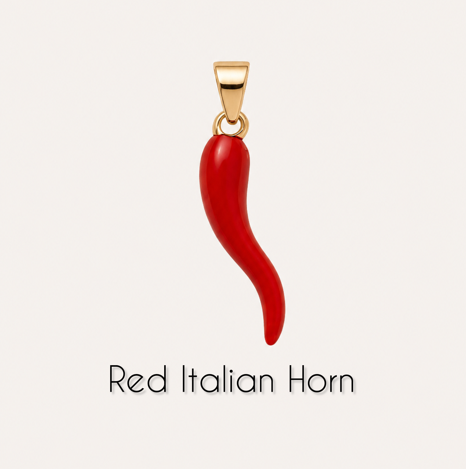 Red Italian horn pendant with gold chain on a light gray background