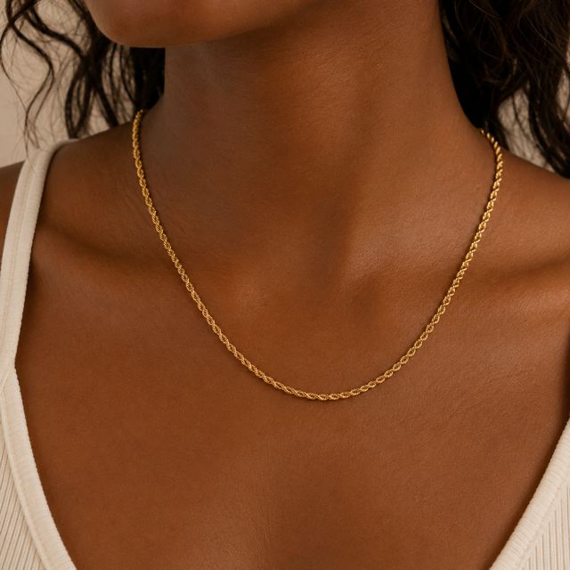 Gold Rope chain necklace on a person with a neutral background