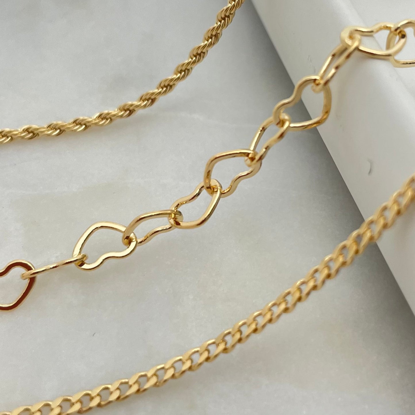 A gold-filled chains anklet bracelet displayed on a flat surface.