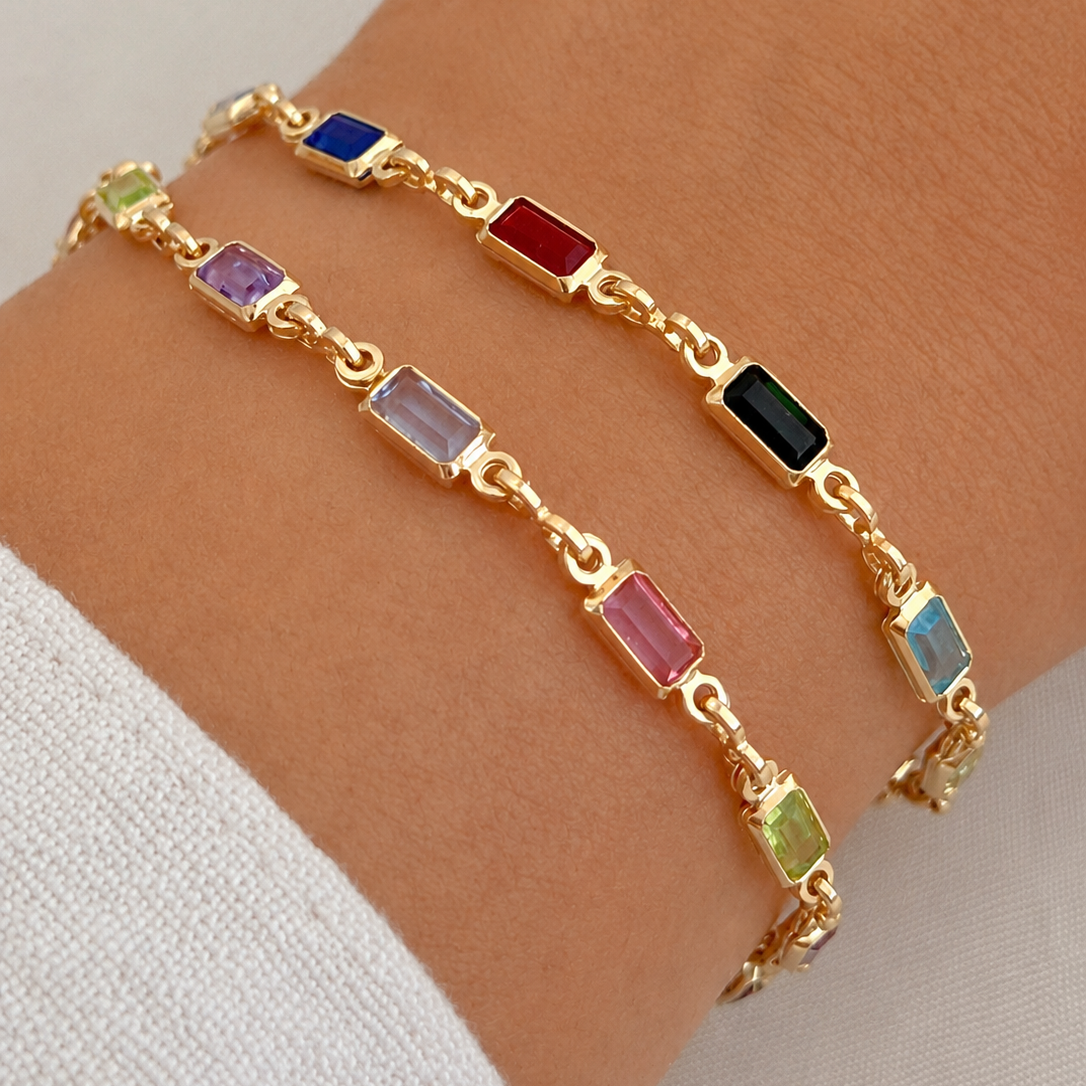 Multicolor bracelets with gold filled details on woman's wrist. 