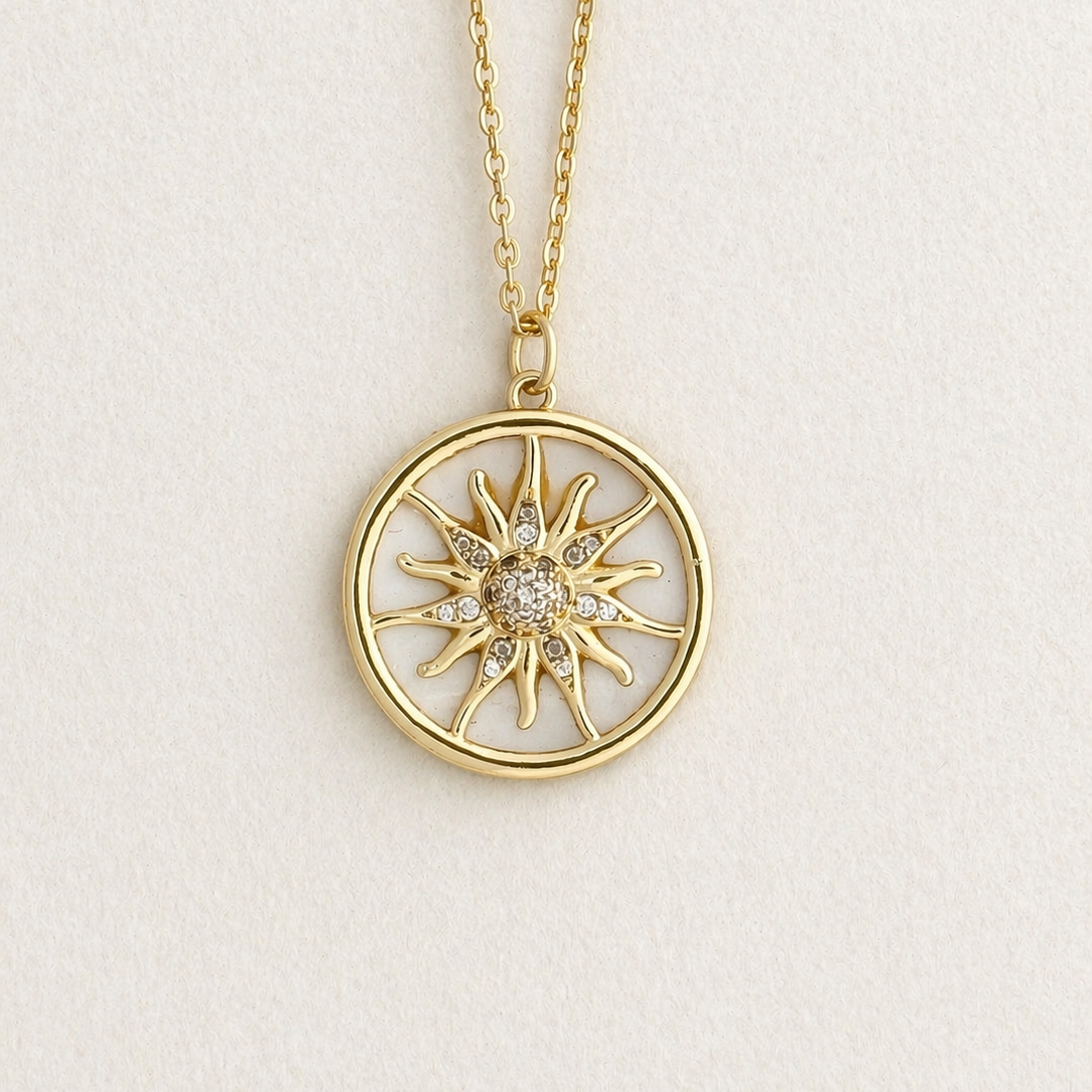 Close up to Gold necklace with a sun-shaped pendant on a light beige background