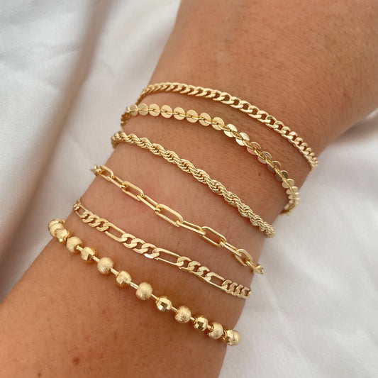 layered bracelets in gold filled on woman's wrist 