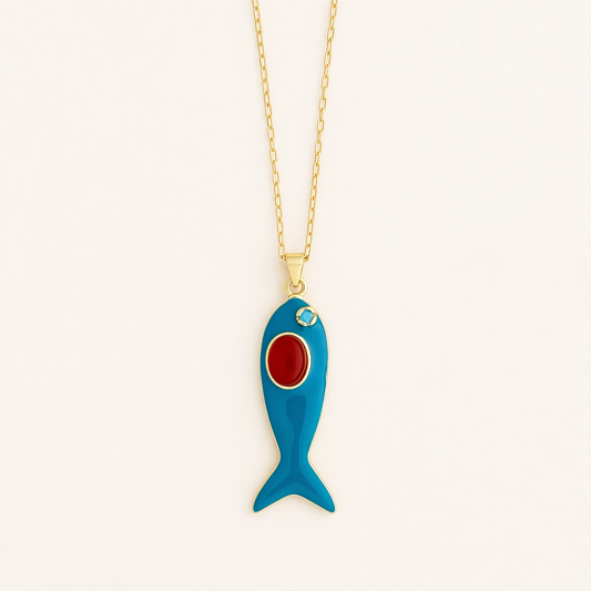 Turquoise enamel fish-shaped pendant with red center and gold chain on white background