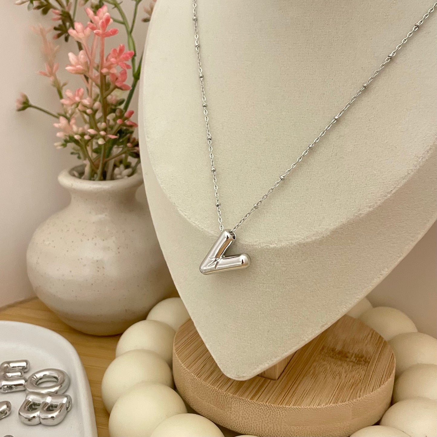 V initial necklace on neck display