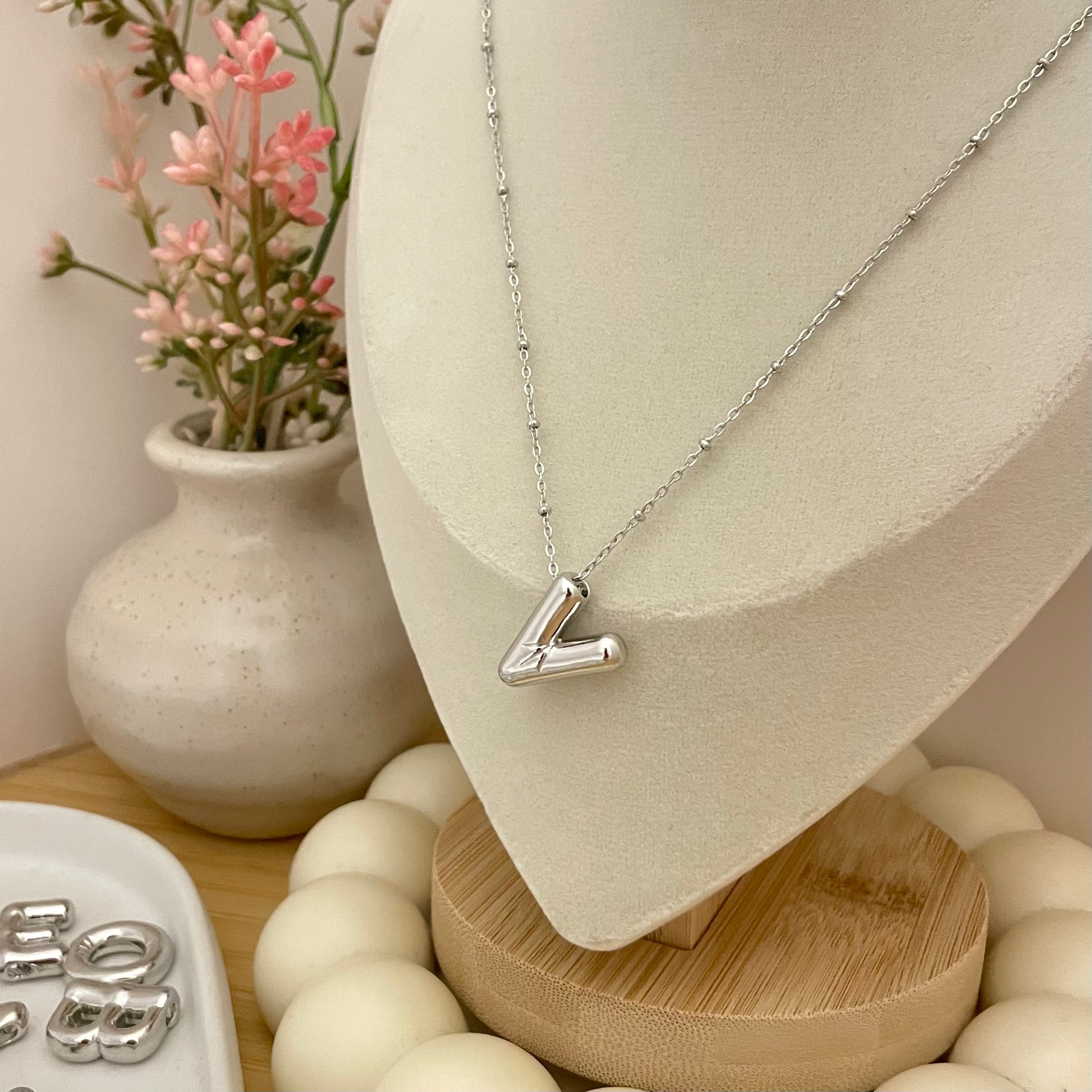 V initial necklace on neck display