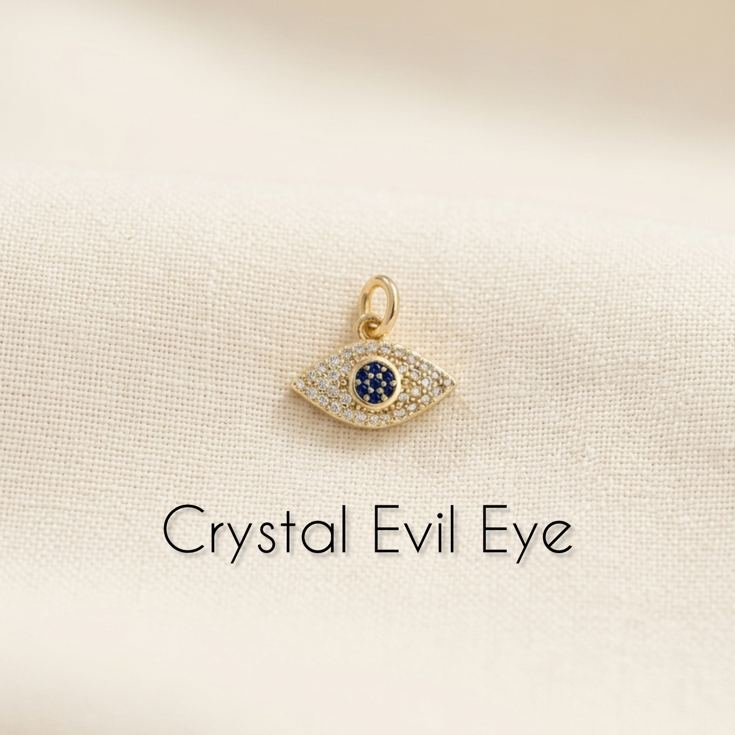 Crystal Evil Eye pendant on a beige background with text 'Crystal Evil Eye'.
