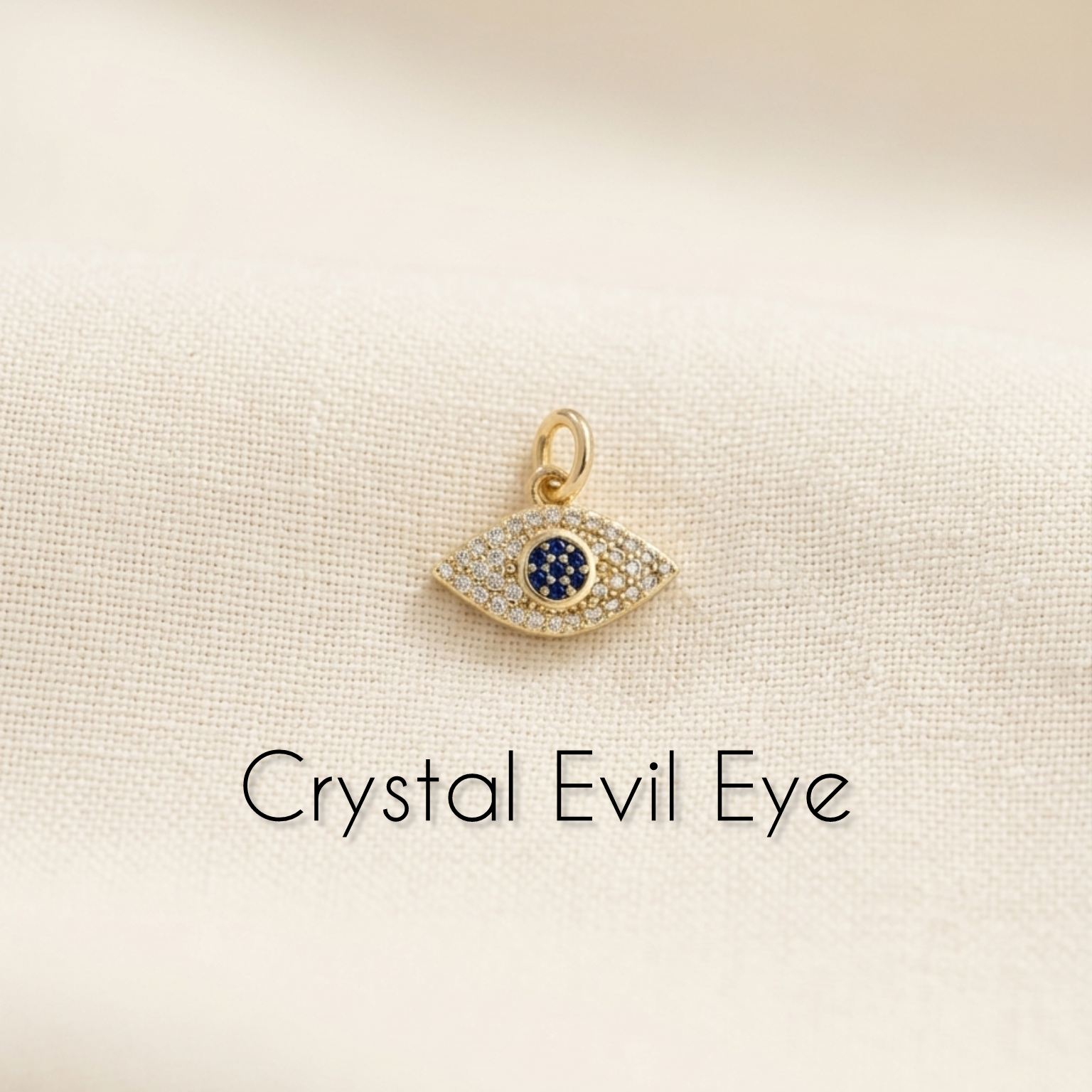 Crystal Evil Eye pendant on a beige background with text 'Crystal Evil Eye'.