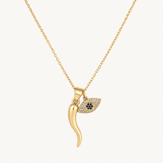 Gold filled  necklace with an italian  horn pendant and evil eye on a white background