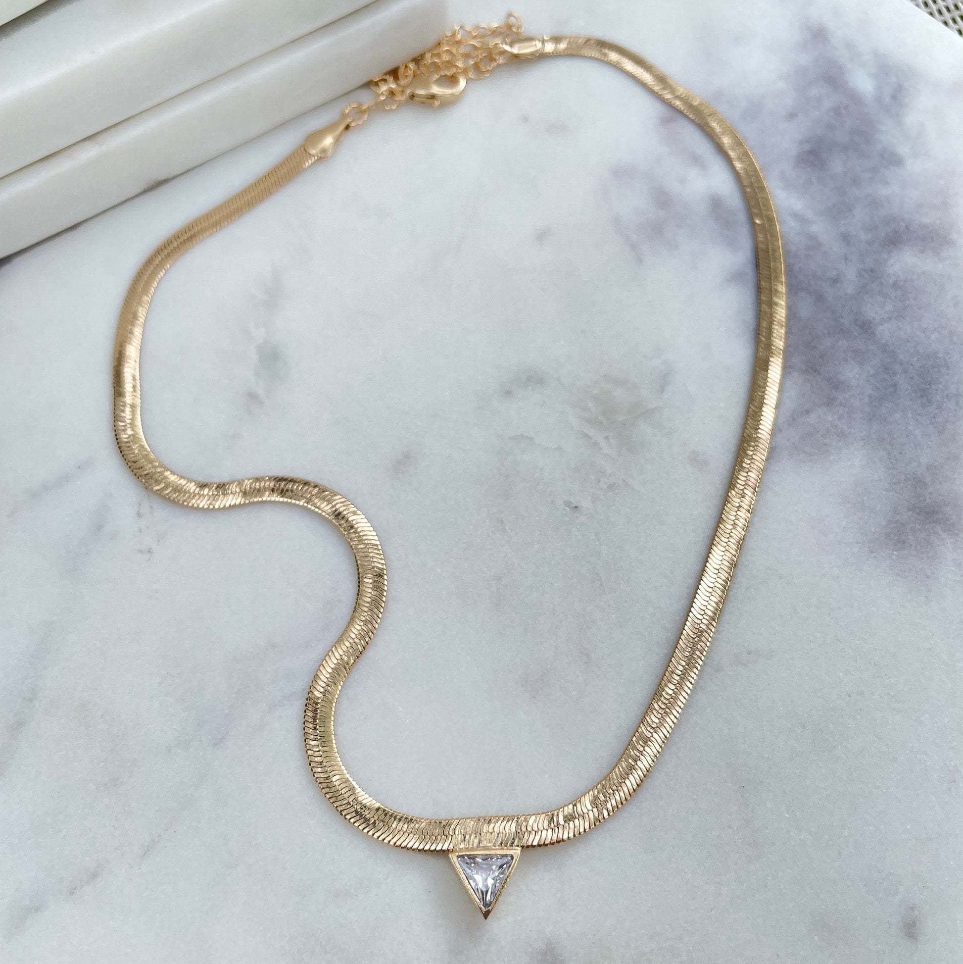 3mm Herringbone necklace with cubic zirconia triangle in the middle, doesn’t flip and comes in 18k gold filled