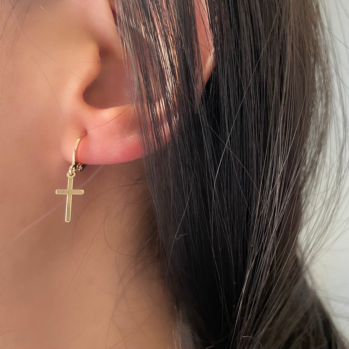 Model Wearing Dangle cross hoop earrings, material 18k gold filled