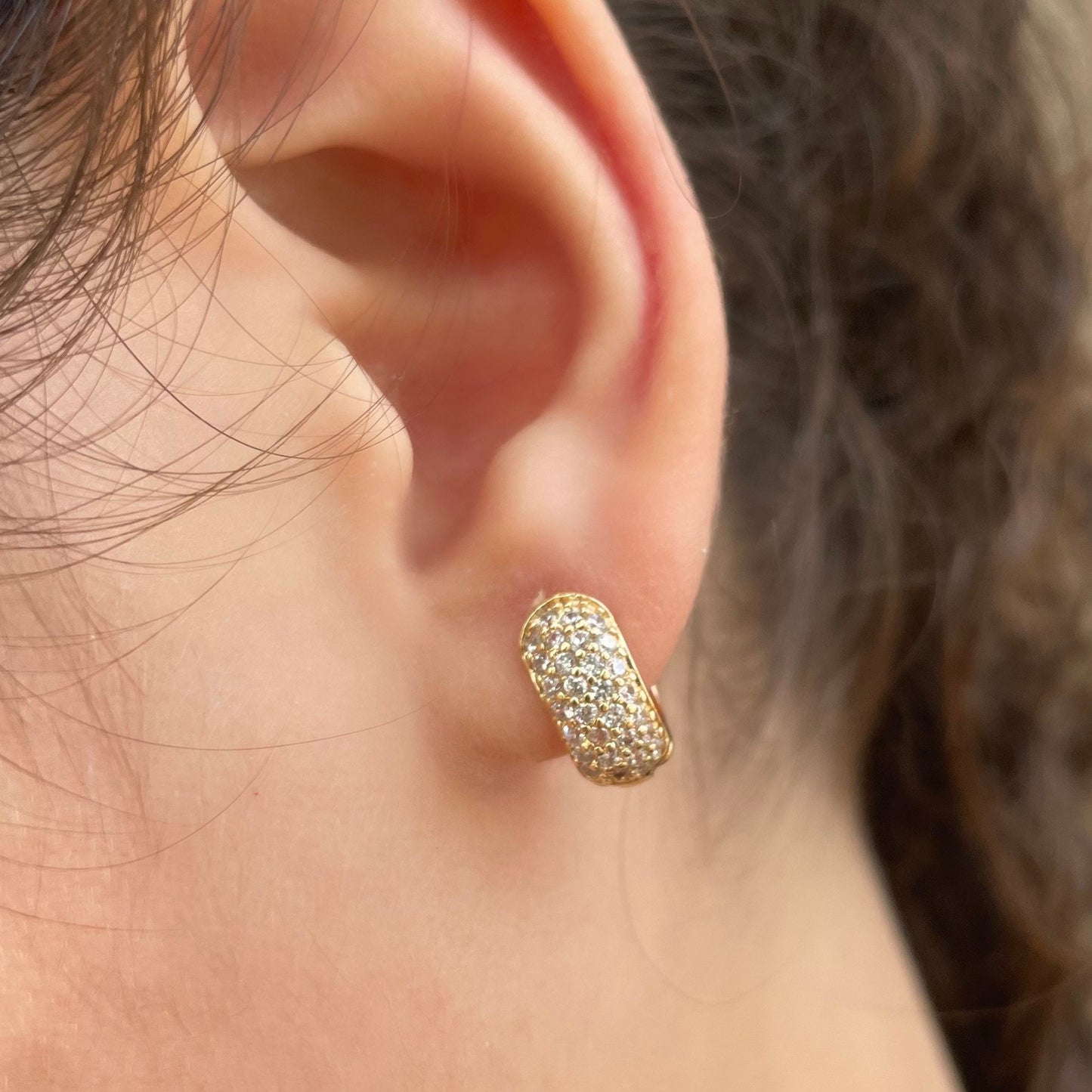 Cz chunky huggie hoop earrings in 18k gold filled. Wore by model. 