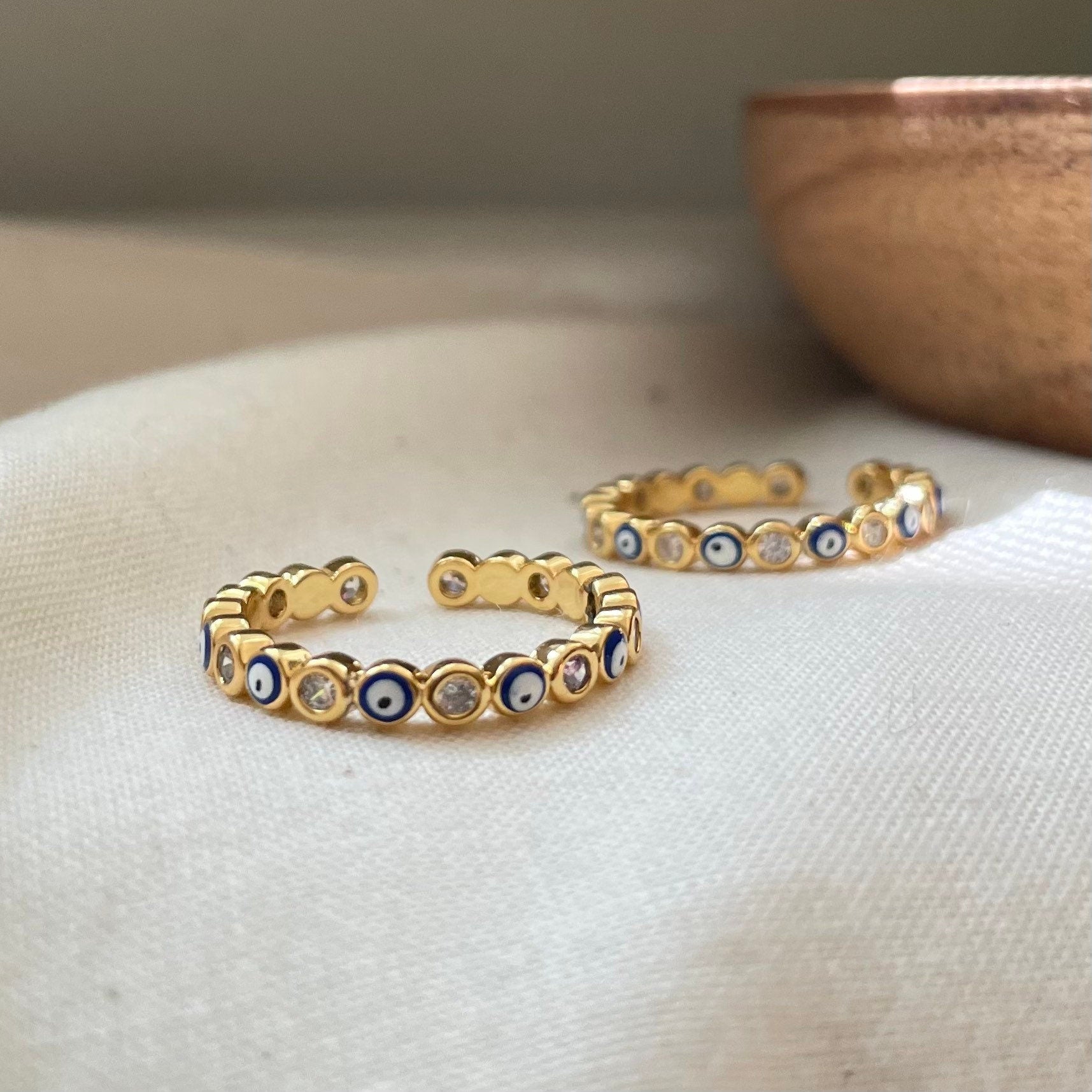 set of blue evil eye stackable rings in gold plated, enamel and cz