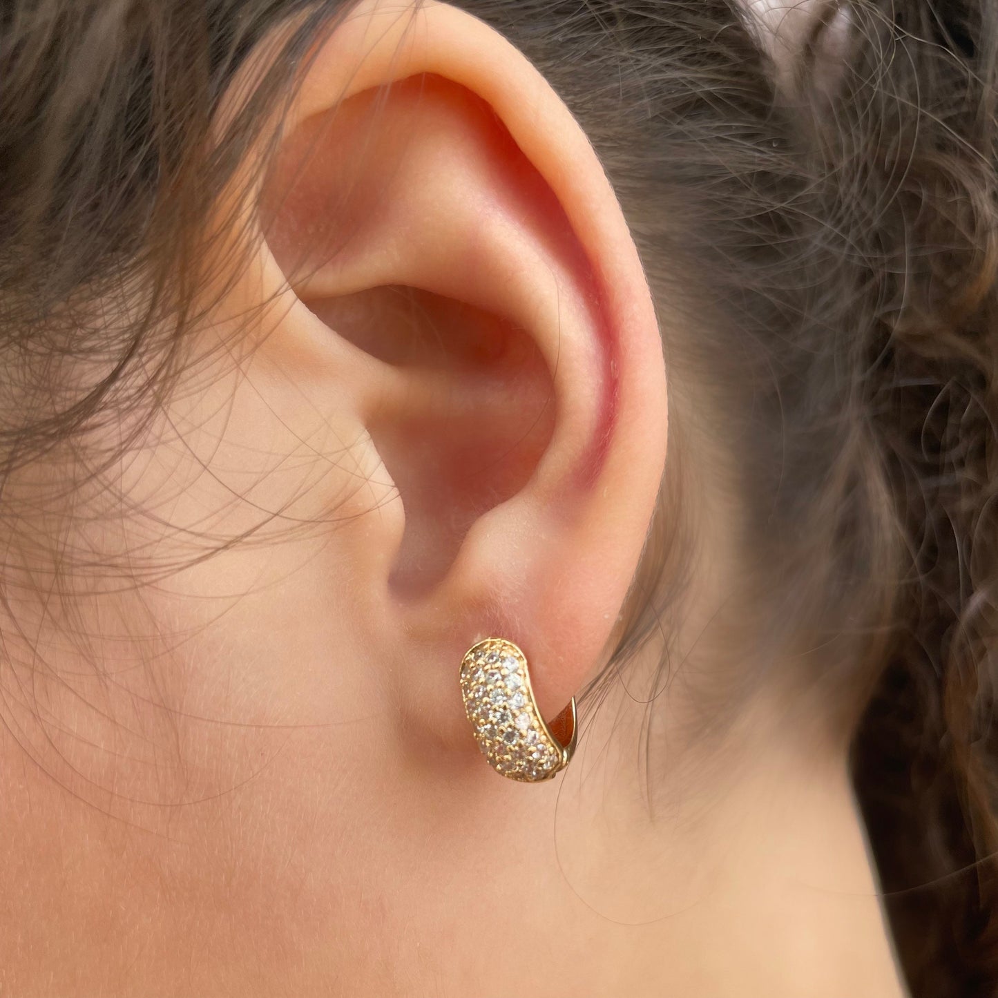 Cz chunky huggie hoop earrings in 18k gold filled. Wore by model. 