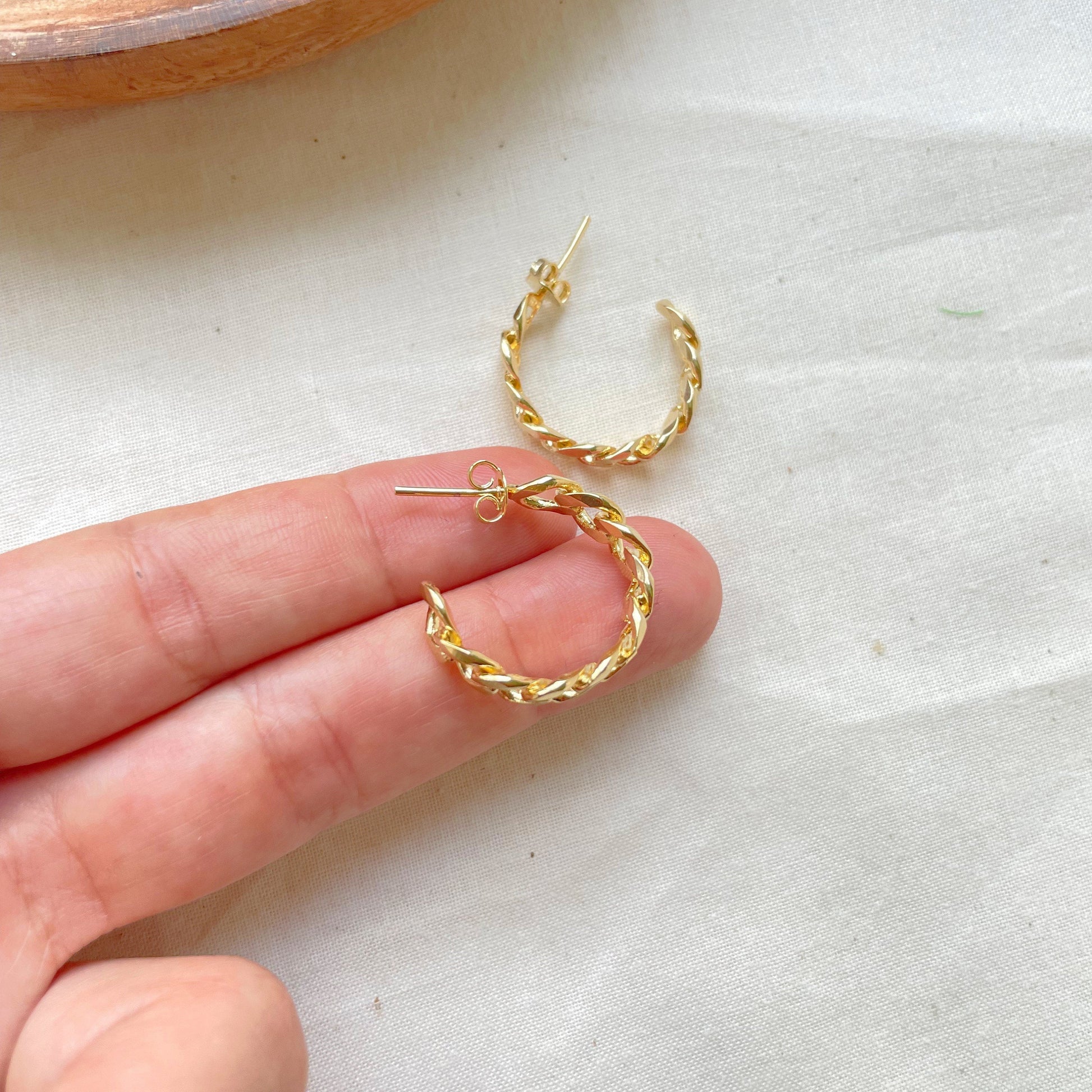 Shown on hand 18k gold filled curb chain hoop earring, thick open hoop, push back earring. White background 