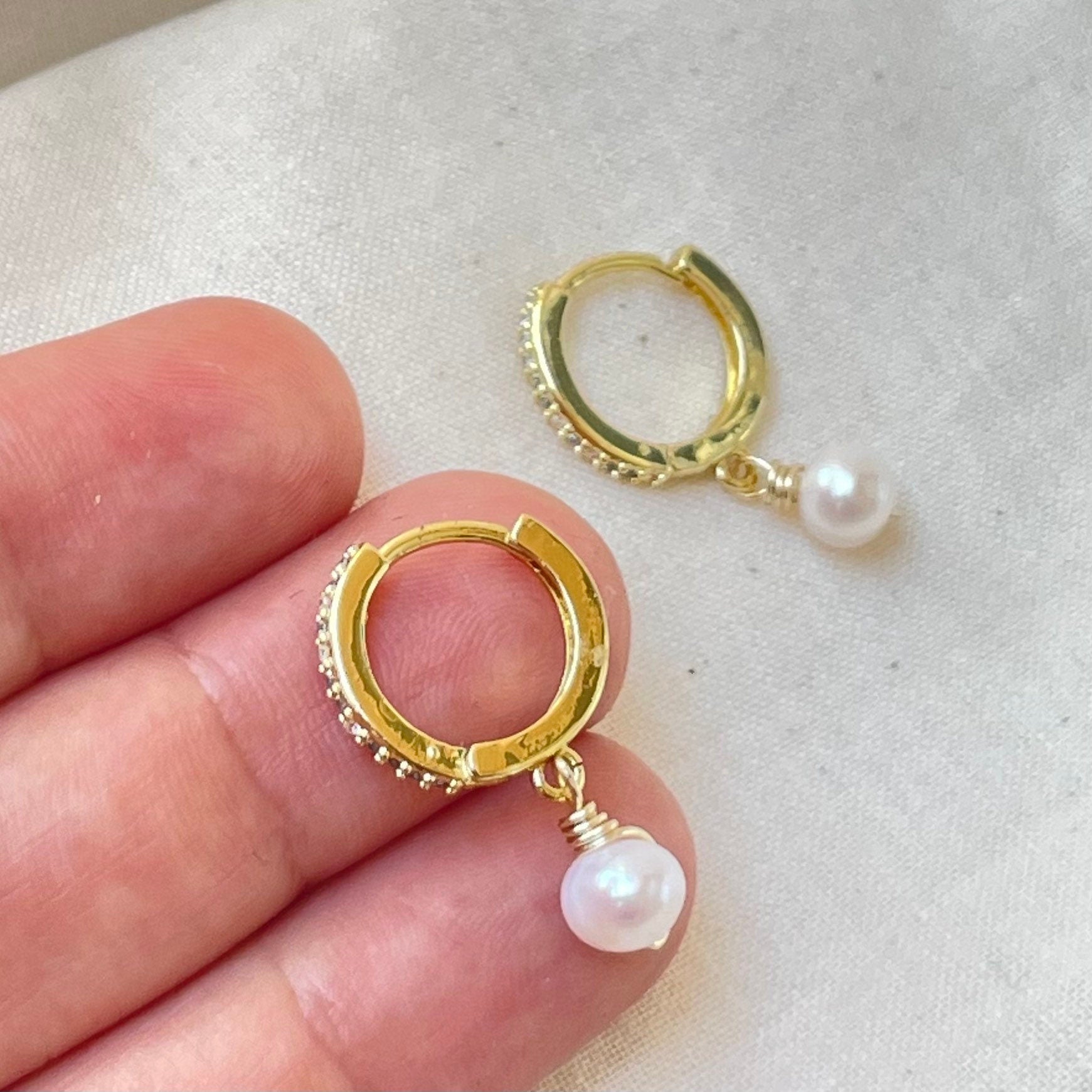 Dangle pearl hoop earrings gold plated, cubic zirconia hoops, natural pearl, fresh water pearl, hold in hand and white background