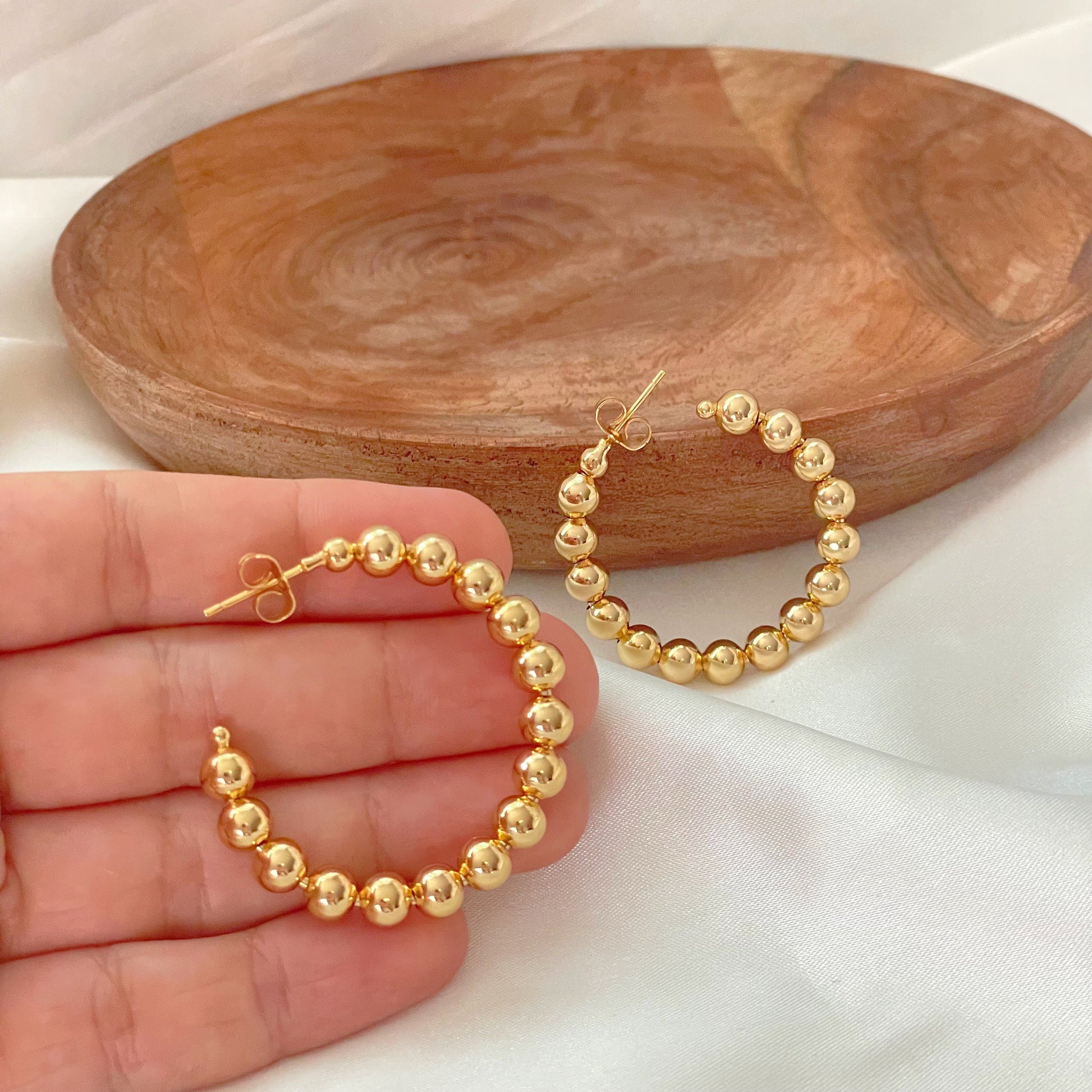 6mm beaded hoop earrings, push back hoop, size 1,5 inches diameter made in 18k gold filled. Displayed on hand 