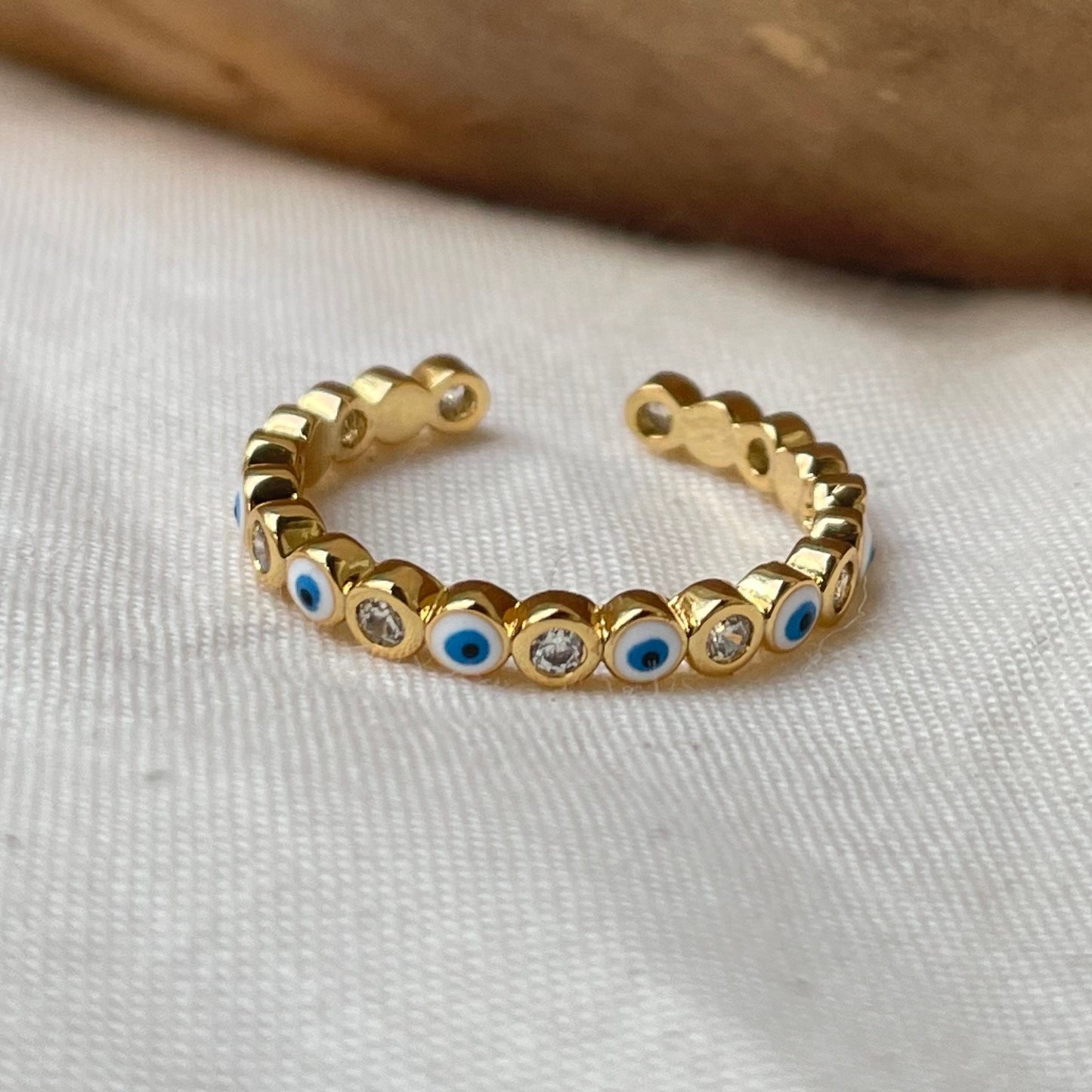 White evil eye stackable ring gold plated, enamel and cz. White background