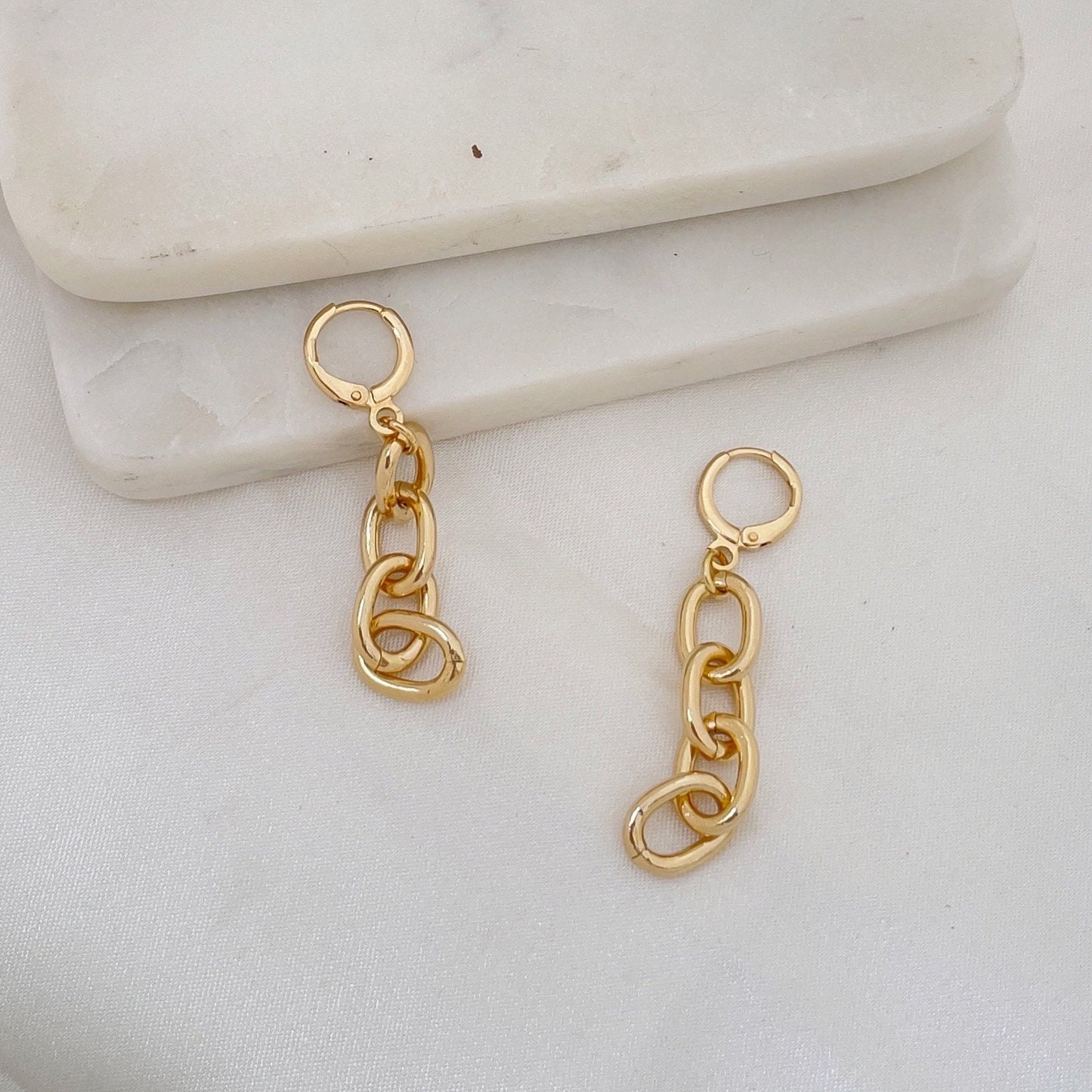 Chain hoop earrings made of 18k gold filled. White silk and marble background