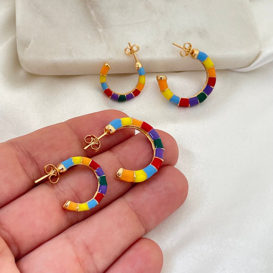 Colorful enamel hoop earrings made of 18k gold filled. Comes in small and medium size. Hold on hand, white silk and marble background 