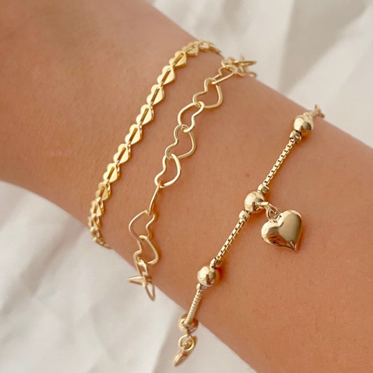 Set of 3 18k gold filled heart bracelets, 3 different styles: full heart bracelet, hollow heart link chain and dangle heart  bracelets. Displayed on arm